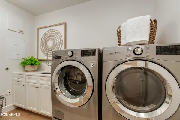 a utility room with sink dryer and washer