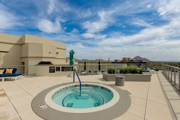 a swimming pool with outdoor seating and city view