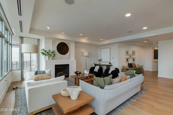 a living room with furniture a fireplace and a flat screen tv