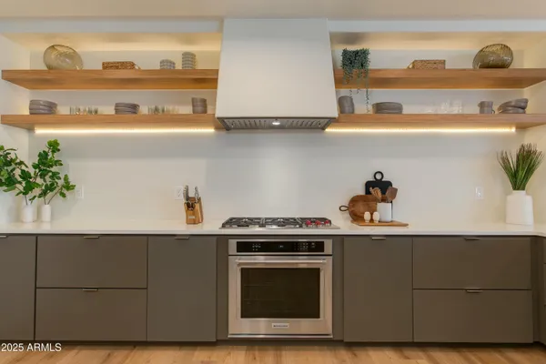 a kitchen with a stove and cabinets