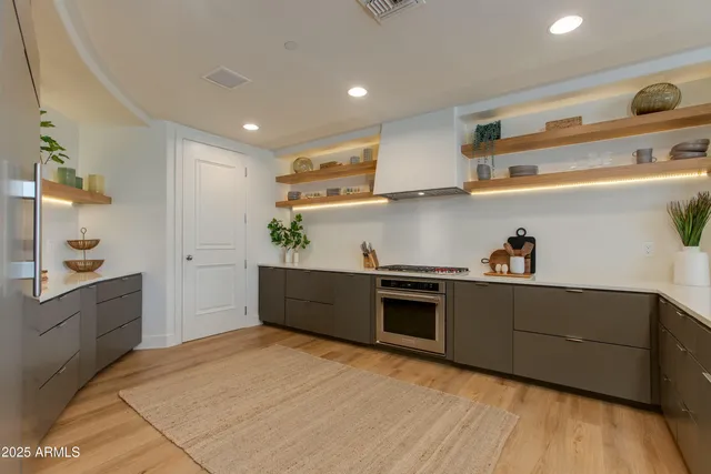 a kitchen with stainless steel appliances granite countertop a sink stove and cabinets