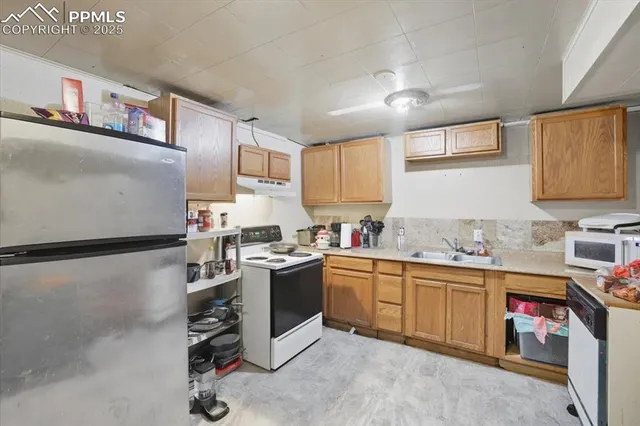 a kitchen with stainless steel appliances granite countertop a refrigerator sink and cabinets