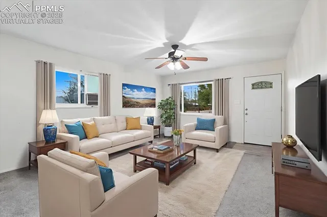 a living room with furniture flat screen tv and a fireplace