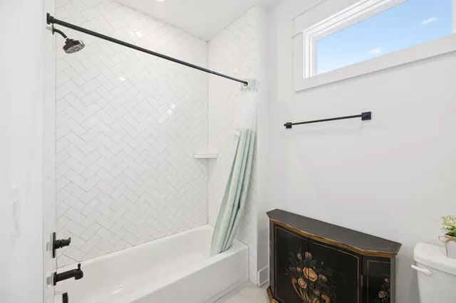 a bathroom with a shower and a bath tub
