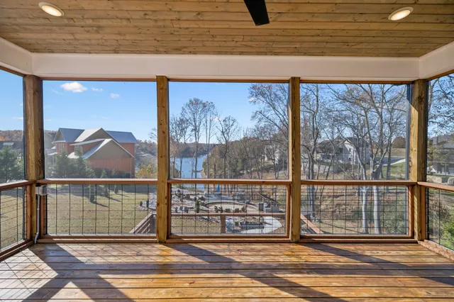 a view of a room with wooden floor and a floor to ceiling window