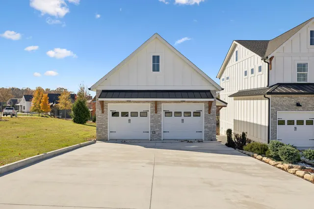 a view of a house with a yard and garage