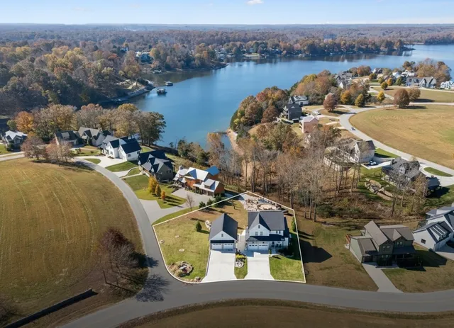 an aerial view of a house with lake view