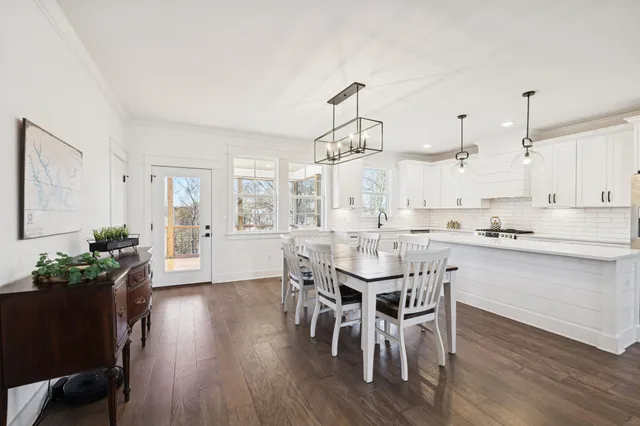 a kitchen with a table and chairs in it