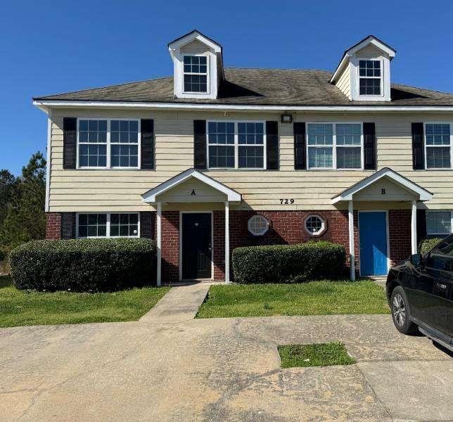 729 Wheel House Lane, Unit A Monroe, GA 30655 - Photo 1 of 1 a front view of a house with a yard and garage