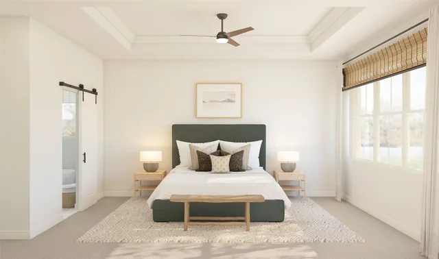 a bedroom with a bed and a large window