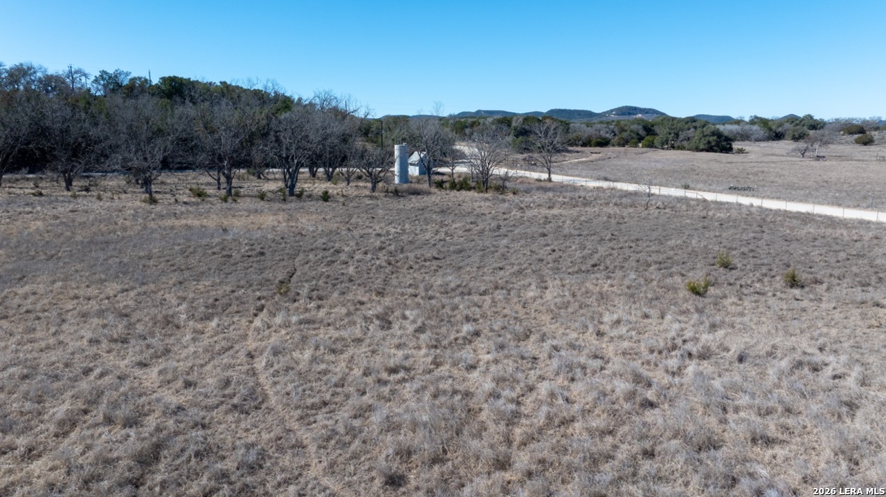 115 Moffett Road Medina, TX 78055 - Photo 10 of 26 a view of dirt field with trees in background
