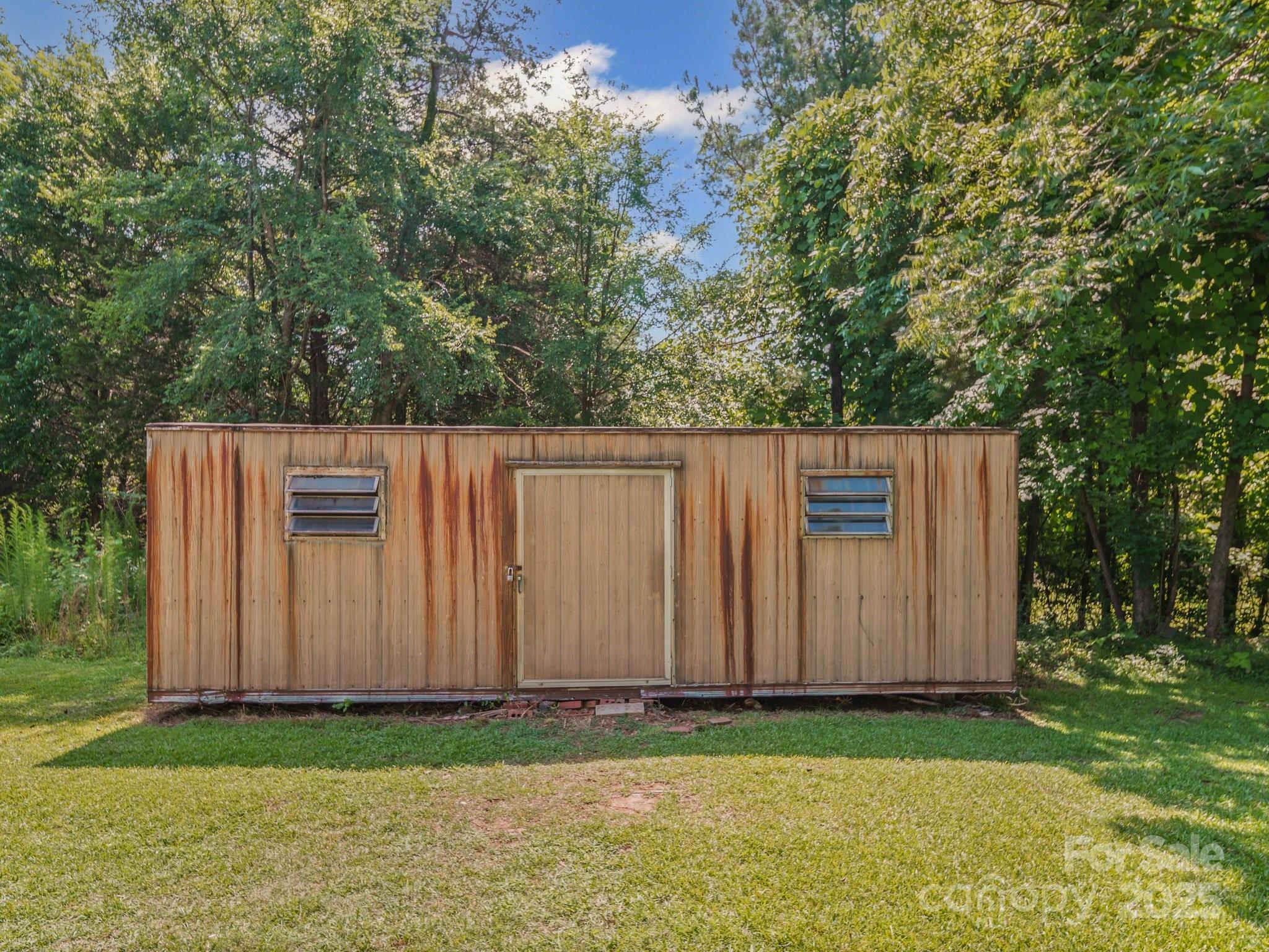 4615 Lockhart Road Sharon, SC 29742 - Photo 16 of 18 a view of a backyard with large trees and wooden fence