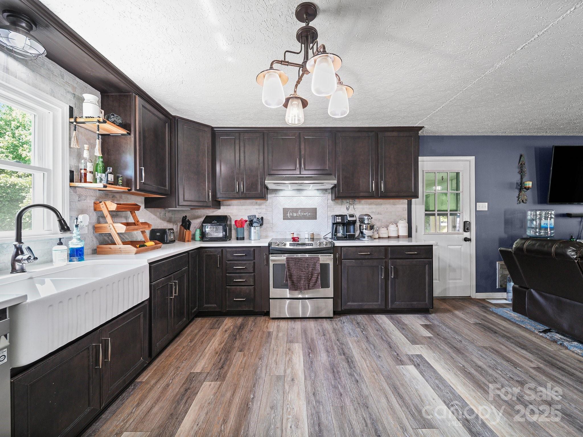 4615 Lockhart Road Sharon, SC 29742 - Photo 3 of 18 a kitchen with a sink wooden cabinets and stainless steel appliances
