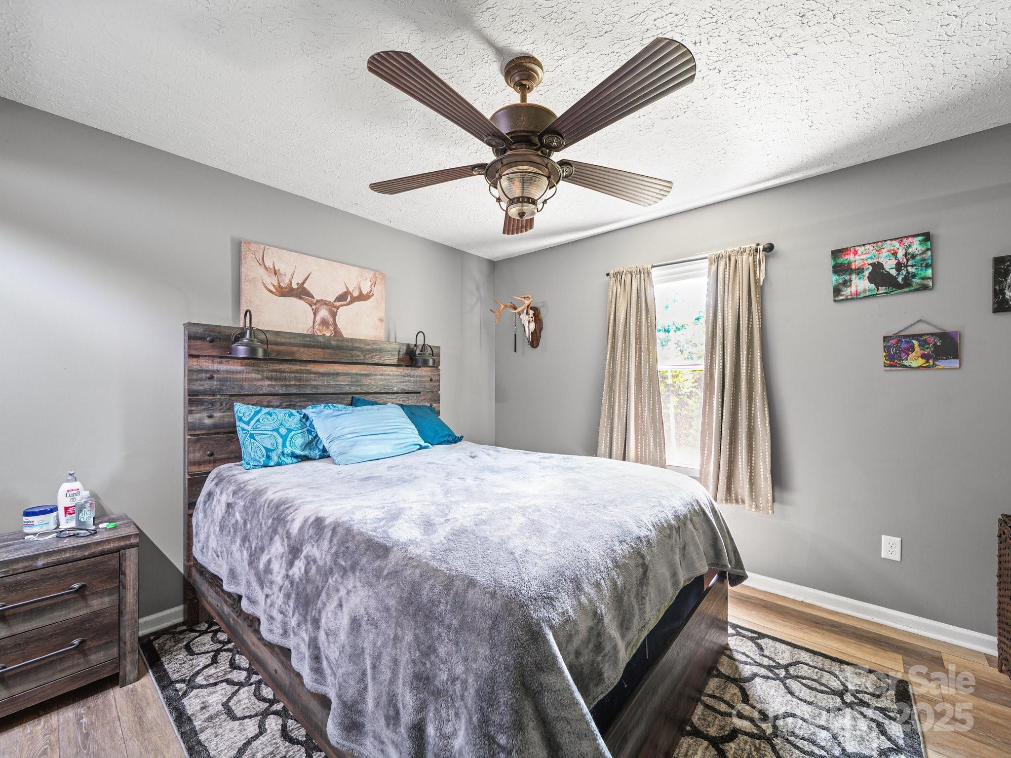 4615 Lockhart Road Sharon, SC 29742 - Photo 6 of 18 a bedroom with a bed and a chandelier