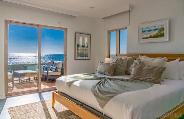 a large bed sitting in a bedroom next to a cabinet
