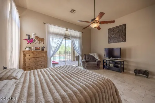 a bedroom with a bed and a flat tv screen