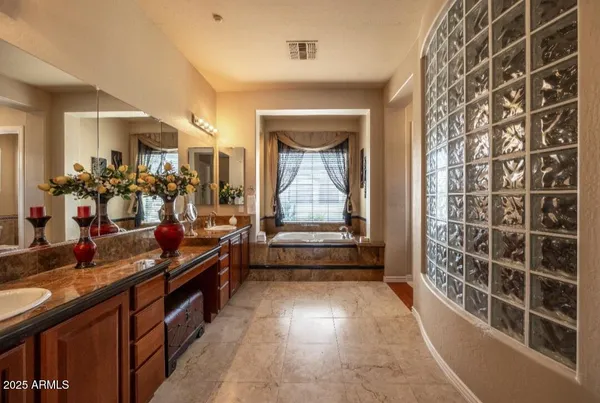 a hallway with a large mirror and cabinets