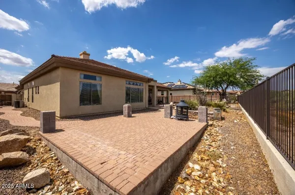 a view of a house with backyard and sitting area