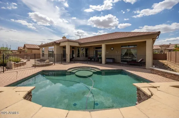 a view of a house with swimming pool and sitting area