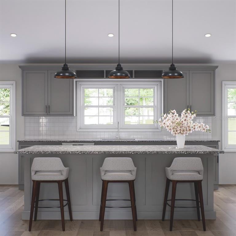 354 Hoot Owl Road Satsuma, FL 32189 - Photo 4 of 20 a kitchen with stainless steel appliances a dining table chairs and white cabinets