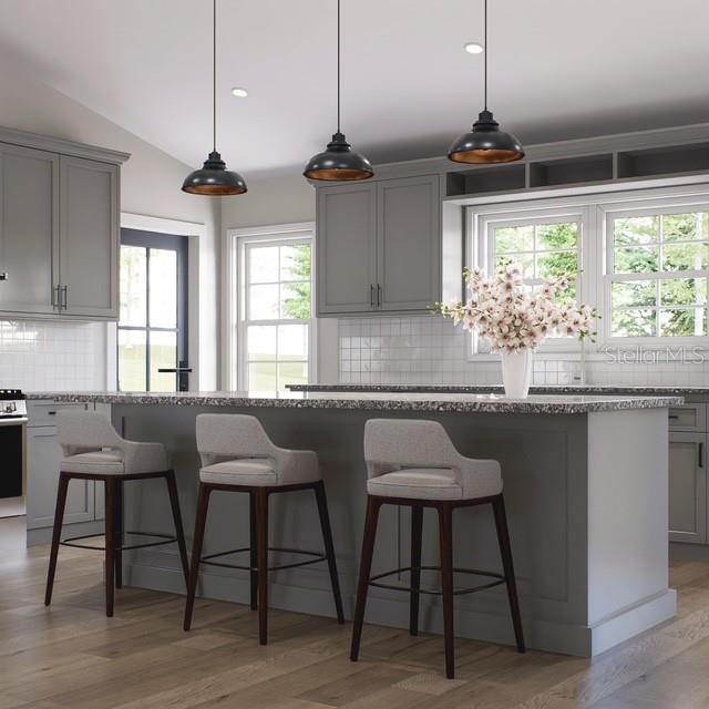 354 Hoot Owl Road Satsuma, FL 32189 - Photo 5 of 20 a kitchen with stainless steel appliances granite countertop wooden floor dining table chairs and granite counter tops