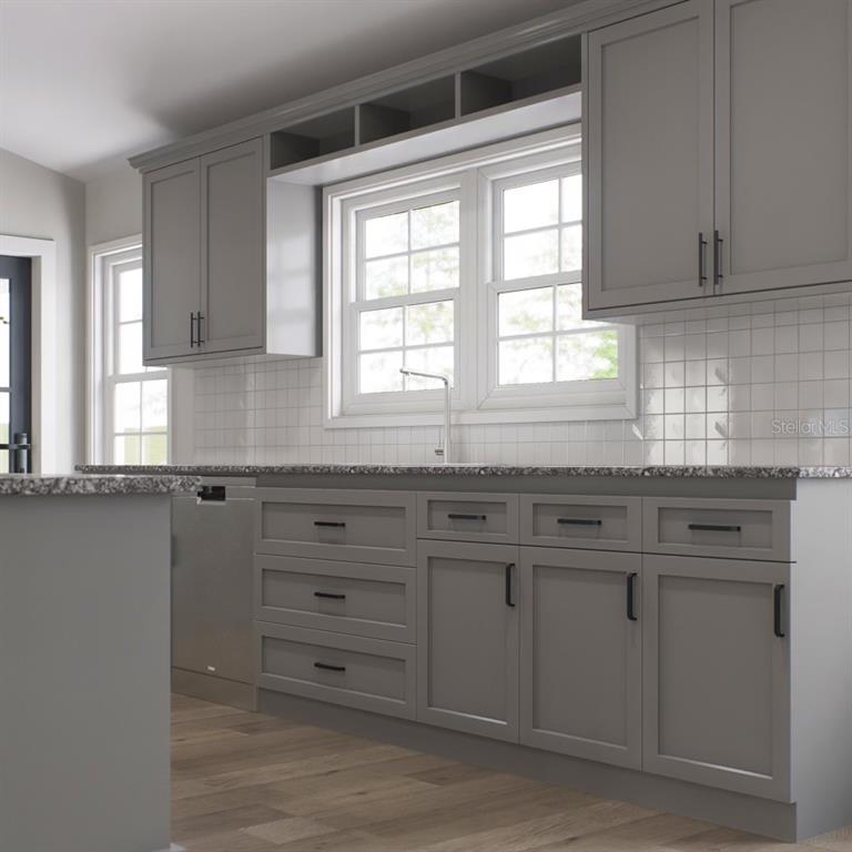 354 Hoot Owl Road Satsuma, FL 32189 - Photo 6 of 20 a kitchen with granite countertop white cabinets and a window