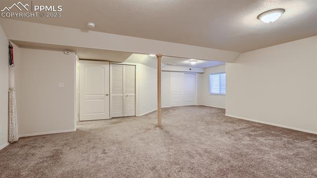 5647 Sonnet Ridge Point Colorado Springs, CO 80918 - Photo 22 of 28 Basement Open Area with Multiple Closets