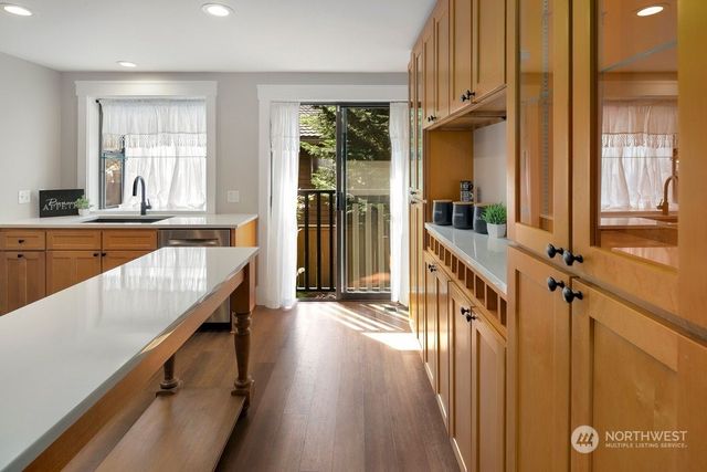a view of a kitchen with an entryway and wooden floor