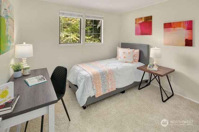 a bedroom with a bed and a chair