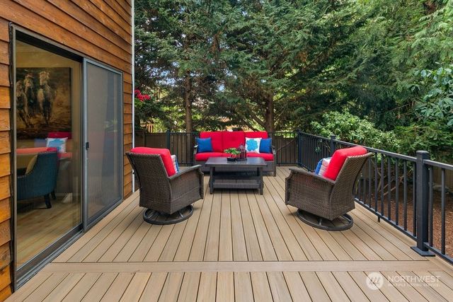 a view of outdoor sitting area with furniture and wooden deck
