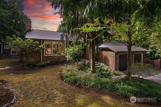 a view of a house with a yard and tree s