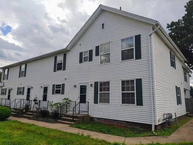 a view of a house with brick walls