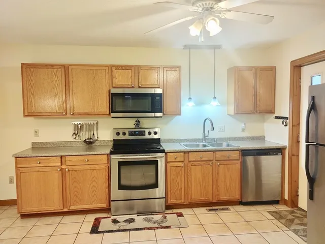 a kitchen with stainless steel appliances granite countertop a sink and a stove