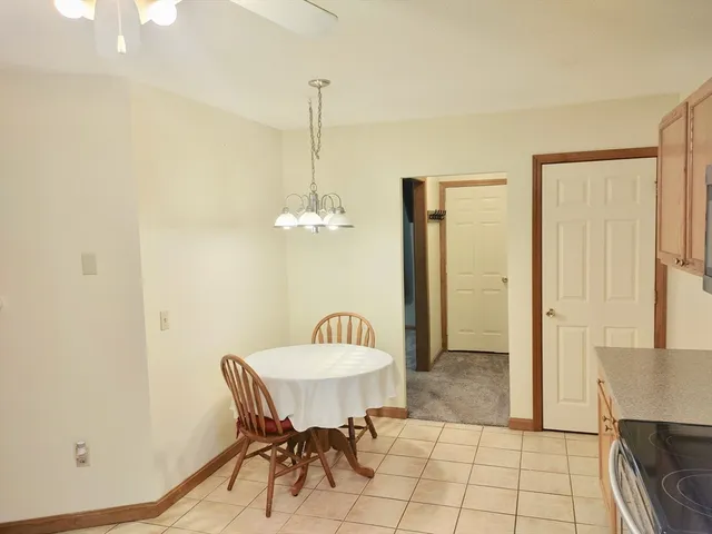 a view of a dining room with furniture and a chandelier