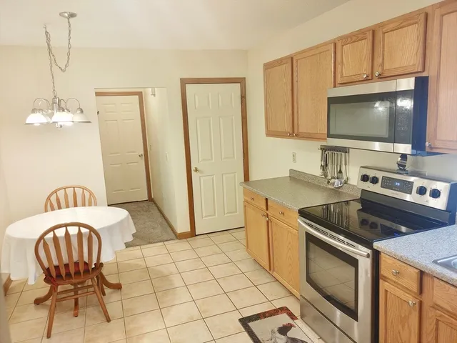 a kitchen with stainless steel appliances granite countertop a sink a stove a microwave a counter space and cabinets