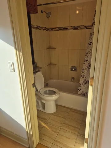 a bathroom with a toilet and a shower