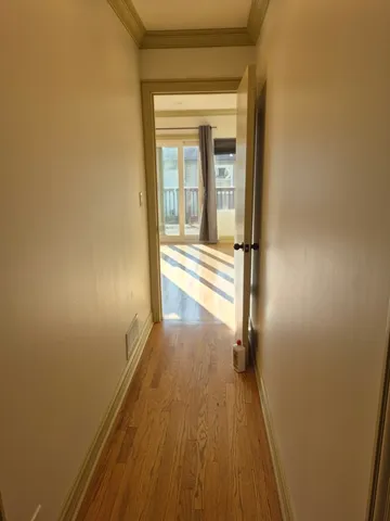 a view of a room with wooden floor and a window