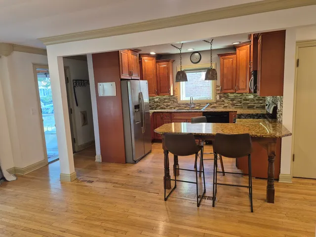 a kitchen with stainless steel appliances granite countertop a stove a refrigerator and a refrigerator