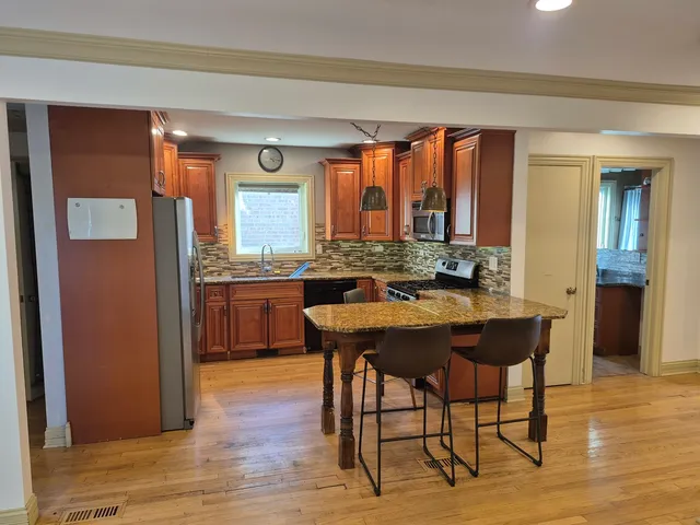 a kitchen with a table and chairs