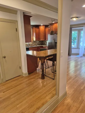 a view of dining room with wooden floor and furniture