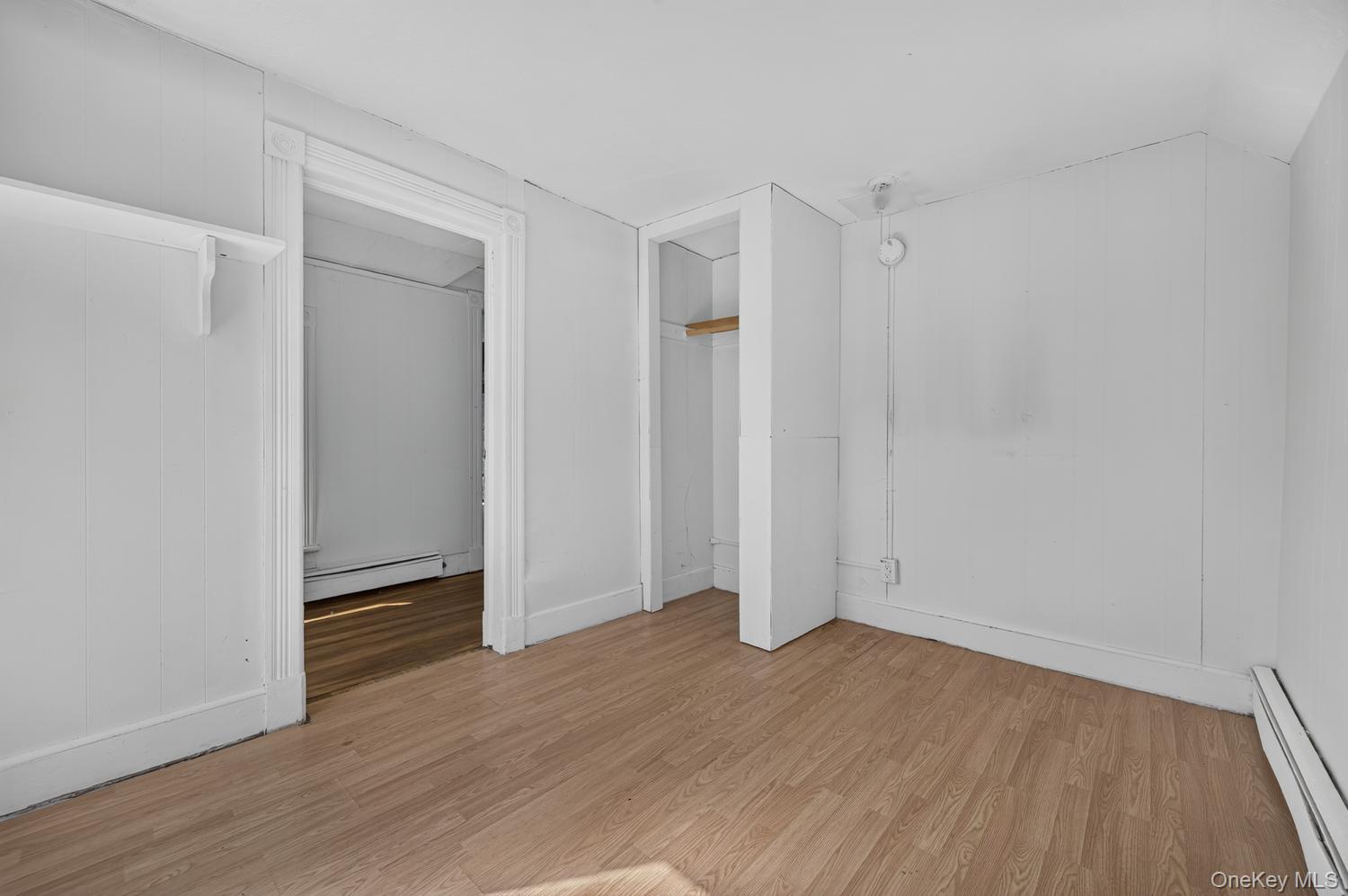 49 Cedar Street Babylon, NY 11702 - Photo 14 of 20 a view of an empty room with wooden floor and a window