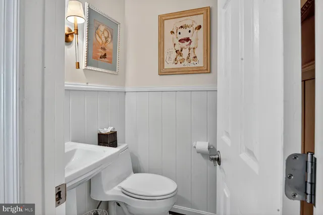 a white toilet sitting next to a bathroom sink