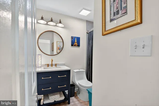 a bathroom with a toilet a sink and a mirror