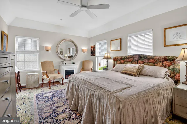 a bedroom with a bed and a refrigerator