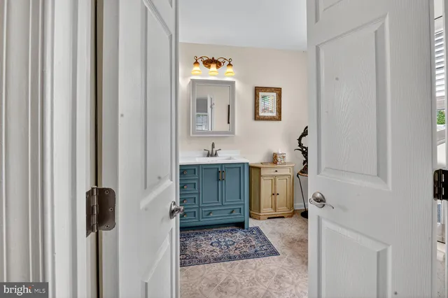 a bathroom with a sink and mirror with toilet