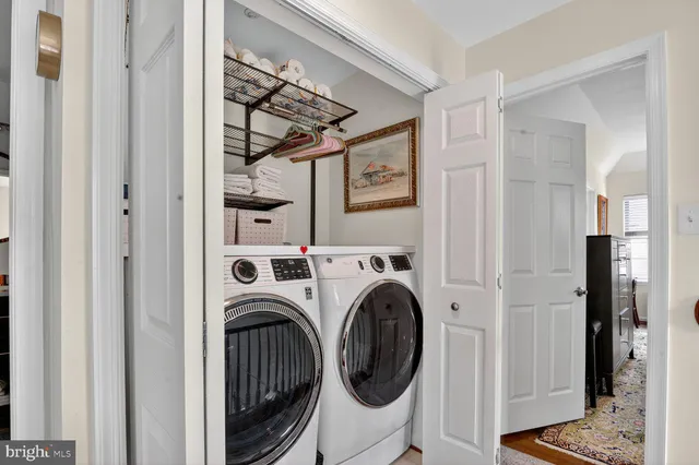 a view of walk in closet with clothes