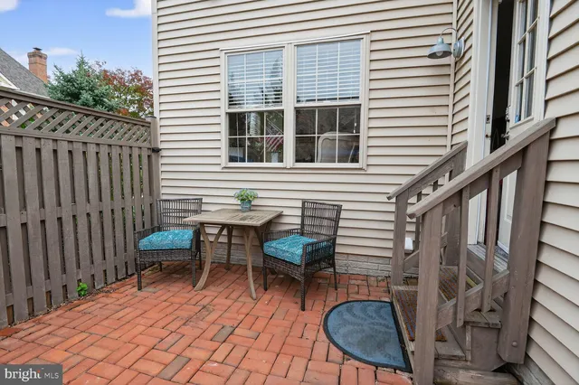 a view of a patio with table and chairs potted plants