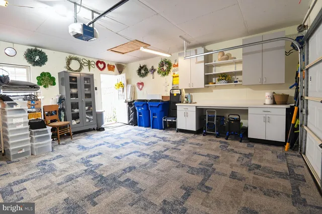 a swimming pool with outdoor seating and wooden fence