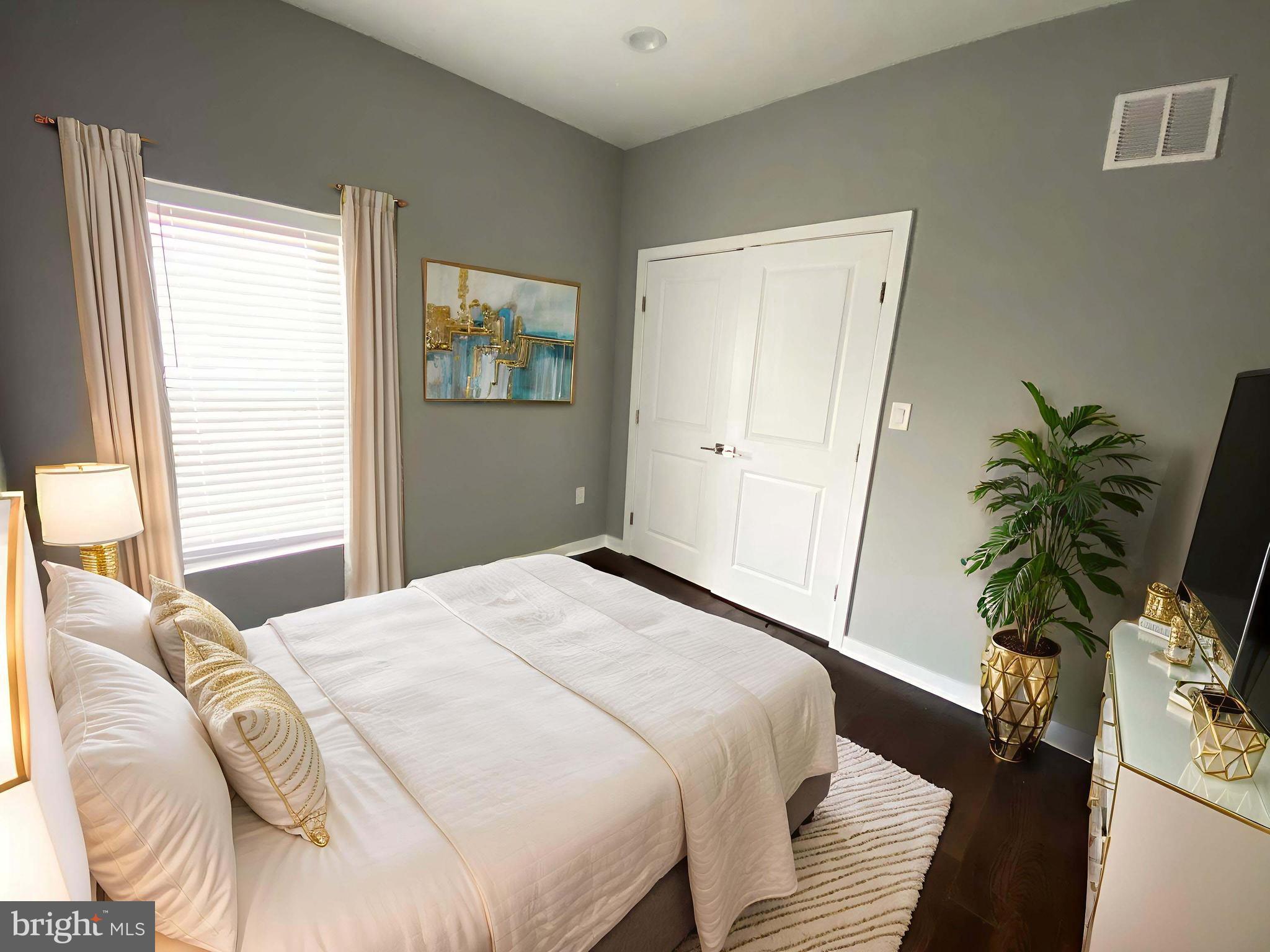 1801 West Venango Street, Unit 4 Philadelphia, PA 19140 - Photo 15 of 21 a bedroom with a bed and a potted plant