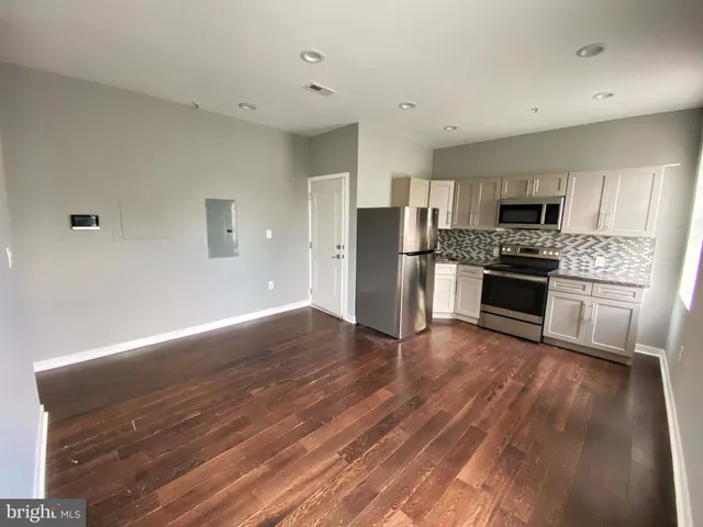 a kitchen with stainless steel appliances granite countertop a stove and a refrigerator